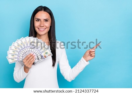 Photo of young girl indicate finger empty space promo direct proposition wealthy profit isolated over blue color background
