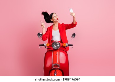 Photo of young girl girl plump lips make take selfie smartphone show peace cool v-sign sit motorbike isolated over pink color background