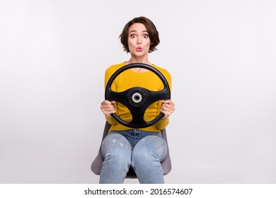 Photo of young girl pouted lips amazed shocked driver transport steering-wheel isolated over grey color background
