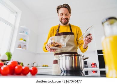 Photo Of Young Guy Cooker Add Homemade Pasta Macaroni Boiling Water Saucepan Healthy Dinner Dieting Indoors