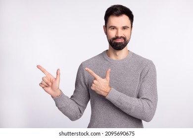 Photo of young guy good mood indicate fingers empty space promoter advise ads isolated over grey color background