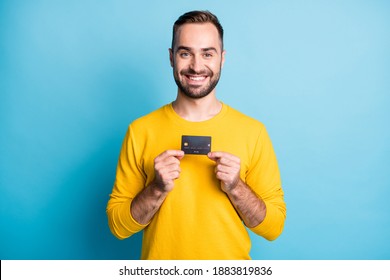 Photo Of Young Handsome Happy Positive Good Mood Smiling Man Hold Show Credit Card Isolated On Blue Color Background