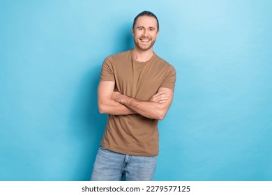 Photo of young handsome influencer guy wear brown t-shirt crossed arms professional remote freelancer copywriter isolated on blue color background - Shutterstock ID 2279577125