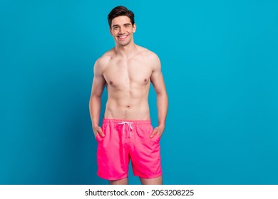 Photo of young handsome man happy positive smile confident cool swimwear isolated over blue color background