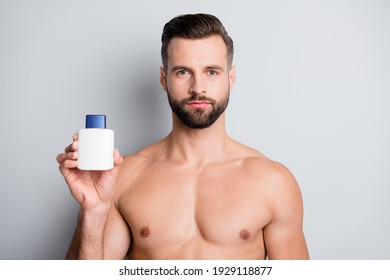 Photo of young handsome man hold aftershave balm cream lotion hydration isolated over grey color background