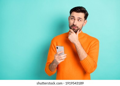 Photo of young handsome man use cellphone hand touch chin think dream look empty space isolated over turquoise color background - Powered by Shutterstock