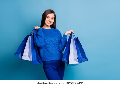 Photo Of Young Happy Positive Good Mood Girl Smiling Hold Shopping Bags On Black Friday Isolated On Blue Color Background