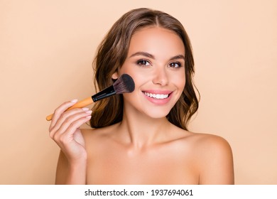 Photo Of Young Happy Smiling Beautiful Woman Doing Contouring Apply Blush On Cheeks Isolated On Beige Color Background