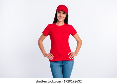 Photo of young happy smiling cheerful delivery service woman in red t-shirt and cap isolated on grey color background
