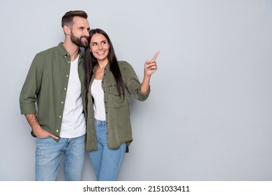 Photo of young husband wife look indicate finger empty space promo banner discount isolated over grey color background - Shutterstock ID 2151033411