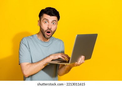 Photo Of Young Impressed Brunet Hair Bristle Beard Open Mouth Unexpected Look You Shocked Breaking News Information Laptop Isolated On Yellow Color Background