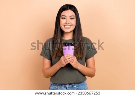 Photo of young japanese woman enjoy drinking starbucks coffee break relax tasty aromatic beverage isolated on beige color background