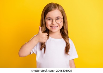 Photo of young little girl happy positive smile show thumb-up like fine recommend ad isolated over yellow color background - Powered by Shutterstock