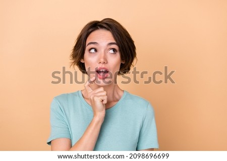 Photo of young lovely woman wonder look empty space impressed idea isolated over beige color background
