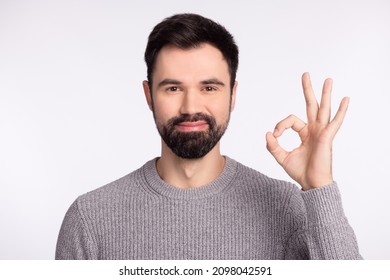 Photo of young man good mood show fingers okey symbol approve quality isolated over grey color background