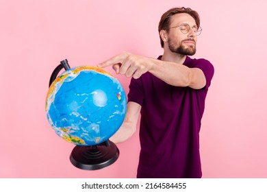 Photo of young man hold globe choose place for vacation abroad select isolated over pink color background