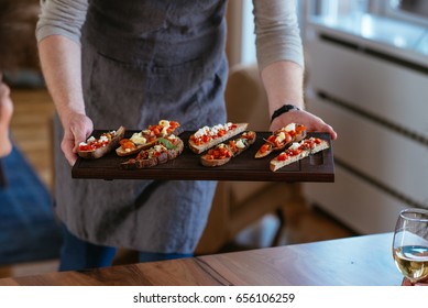 Photo Of A Young Man Serving Food.