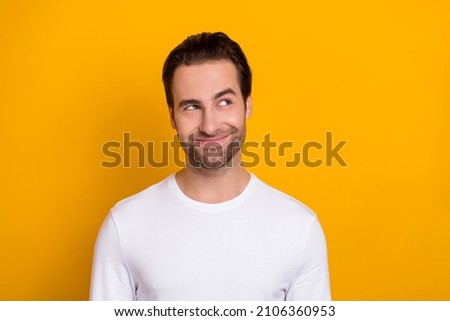 Photo of young man wondered look empty space thoughtful dreamy isolated over yellow color background