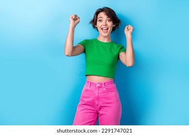 Photo of young overjoyed funny girl raise fists up scream yell successful victory competition first place isolated on aquamarine color background - Powered by Shutterstock