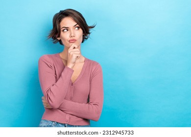 Photo of young ponder thoughtful woman wear trendy pink top touch chin look empty space distrust minded isolated on blue color background - Powered by Shutterstock