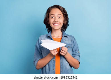 Photo of young preteen boy happy positive smile hold paper plane origami isolated over blue color background - Powered by Shutterstock