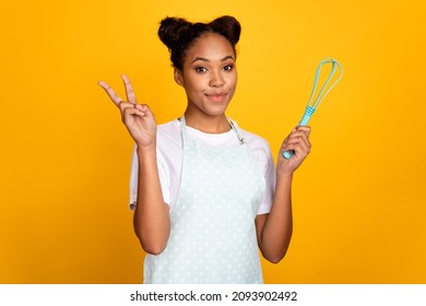 Photo of young pretty african woman cooking bake show fingers peace cool v-symbol isolated over yellow color background - Powered by Shutterstock