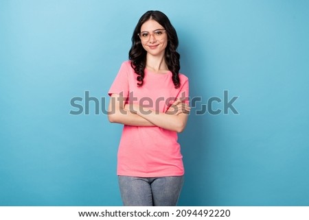 Photo of young pretty cute woman good mood folded hands wear specs isolated over blue color background