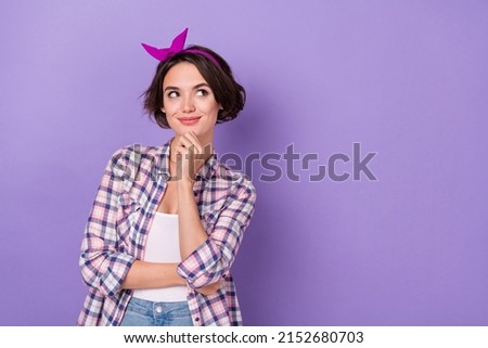 Photo of young pretty girl curious hand touch chin look empty space think isolated over violet color background