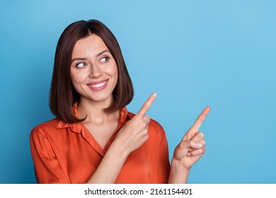 Photo of young pretty girl look indicate fingers empty space advert select direct isolated over blue color background - Shutterstock ID 2161154401