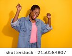 Photo of young pretty girl rejoice victory fists hands awesome champion fan isolated over yellow color background