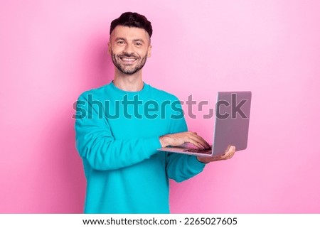 Photo of young programmer cheerful brunet hair guy hold his new hp elitebook laptop for education typing keyboard isolated on pink color background