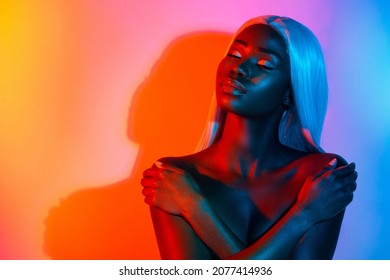 Photo of young sensual flawless stunning afro woman enjoying embrace herself isolated on bright glowing background