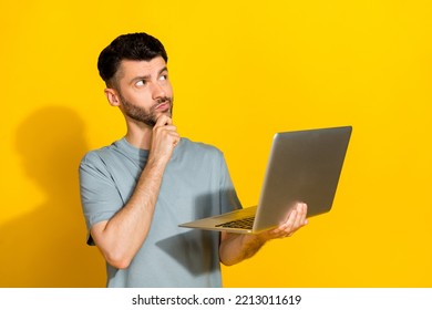 Photo Of Young Serious Ponder Genius Programmer Guy Wear Grey T-shirt Touch Chin Minded Looking Empty Space Eureka Idea Isolated On Yellow Color Background