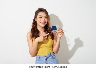 Photo Of Young Smiling Asian Woman Holding Card