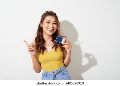 Photo Of Young Smiling Asian Woman Holding Card