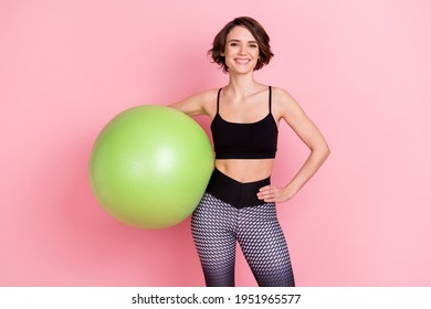 Photo of young sportive girl happy positive smile hold fitball aerobic training isolated over pink color background