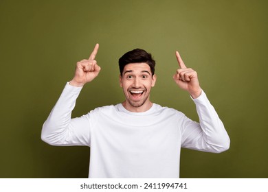 Photo of young surprised funny guy promoting new marketing banner presentation mockup above head isolated on khaki color background - Powered by Shutterstock