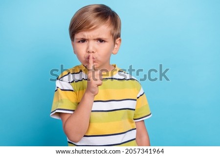 Photo of young unhappy negative upset boy hold finger lips voiceless mute isolated on blue color background