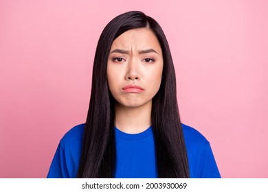 Photo of young unhappy upset young woman sullen face bad mood isolated on pastel pink color background