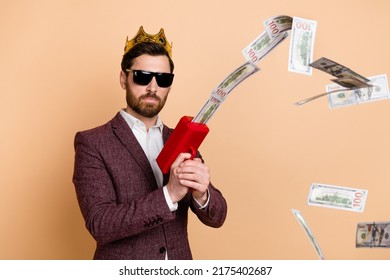 Photo Of Young Wealthy Businessman Investor With Crown On Head Shoot Money Isolated On Beige Color Background