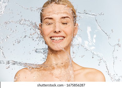 Photo Of  Young  Woman With Clean Skin And Splash Of Water. Portrait Of Smiling Woman With Drops Of Water Around Her Face. Spa Treatment. Happy Girl Washing Her Body With Water. Water And Body.