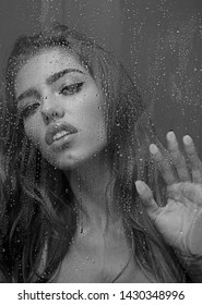 Photo Of Young Woman Draws On Weeping Glass Shower Door, Enjoys Rest In Douche, Washes Her Body, Stands Behind Steam Blurred Glass With Water Drops. Rest At Bathroom