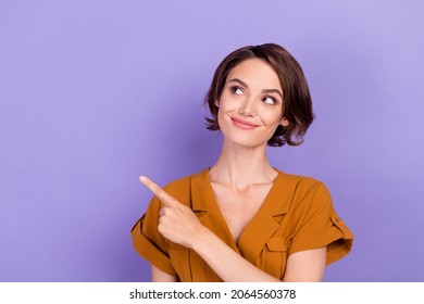 Photo of young woman happy positive smile look indicate finger empty space recommend sale isolated over violet color background