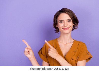 Photo of young woman happy positive smile indicate fingers empty space direct promo ads isolated over violet color background