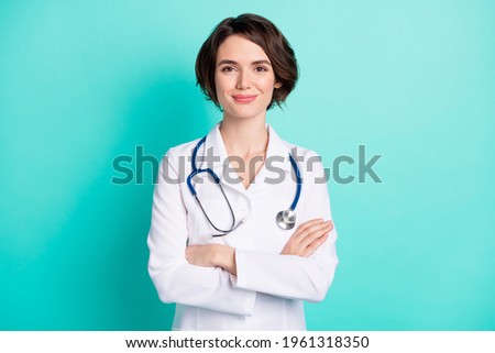 Photo of young woman happy positive smile folded hands intern medic isolated over teal color background