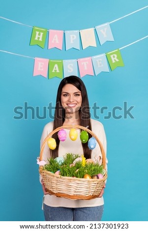 Photo of young woman hold wicker with eggs easter deliver present isolated over blue color background