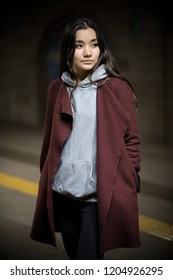 Photo Of Young Woman In Night Subway. Looking To The Side