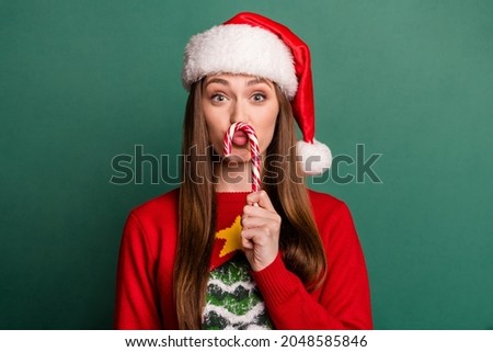 Photo of young woman plump lips fooling candy sweet christmas spirit isolated over green color background