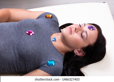 Photo Of Young Woman Undergoing Hypnotherapy With Stones