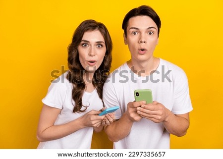 Photo of youth bloggers wearing white t-shirt pouted lips surprised eshopping proposition amazon black friday isolated on yellow color background